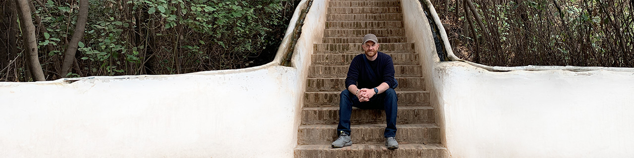 Anthony Ongaro at the Alhambra, sitting on steps of water rails.